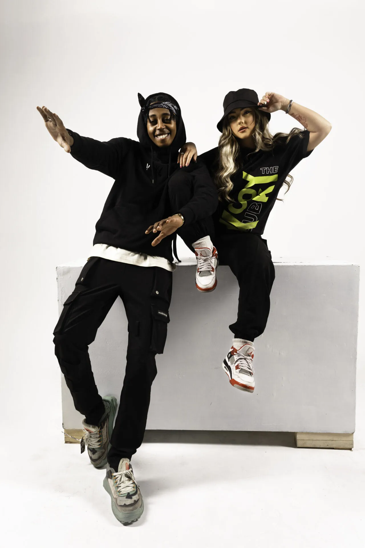 Two Kooky Club models wearing branded streetwear in a studio